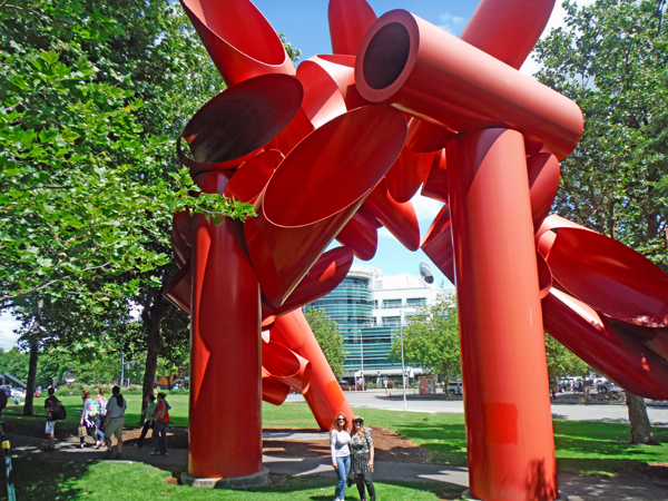 Karen Duquette and her sister Ilse under the artwork